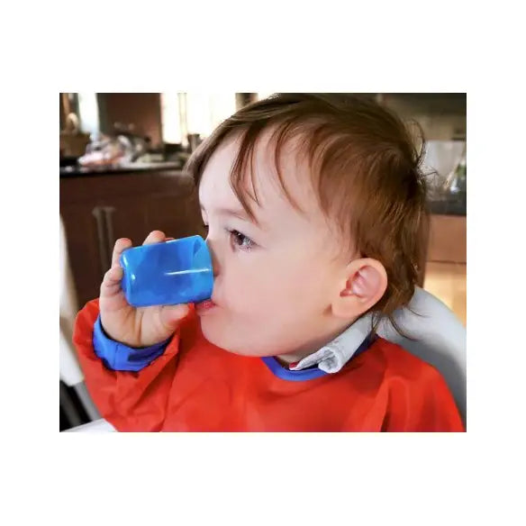 Bebé bebiendo agua de un vaso Babycup azul